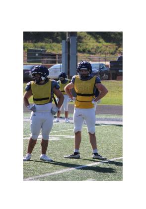 Mikey Moreno, left, and James Hart get a defensive call during the team's practice Tuesday afternoon at Warrior Stadium.  MARK TURNER/WCN