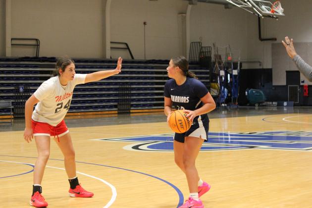 White County's Ansleigh Vandiver looks to make a pass during the Lady Warriors' game last week against Milton High School at the UNG Team Camp in Dahlonega. Vandiver hit a 3-pointer in the final seconds of regulation to send the game to sudden death overtime, but Milton scored on the first possession of OT to take a 54-52 win.   MARK TURNER/WCN