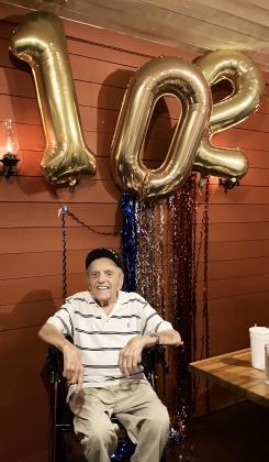 White County resident Andy Negra, 102, grins below his birthday balloons last weekend during a celebratory dinner at Nacoochee Grill. SUBMITTED PHOTOS