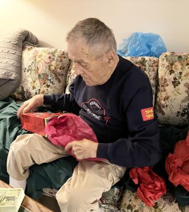 Andy Negra opens birthday gifts at his Skylake home. Negra just celebrated turning 102. SUBMITTED PHOTOS