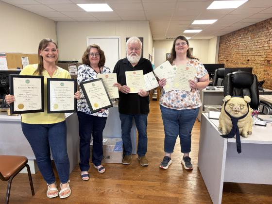 Members of the White County News staff were presented with numerous Georgia Press Association awards earlier this month. From left: General Manager Erin Etris, Managing Editor Denise Etheridge, Columnist Emory Jones, Page Designer Mary Beth Yeary and Jones’ pet pig Cunningham. PHOTO BY CARLY HENDERSON/WCN