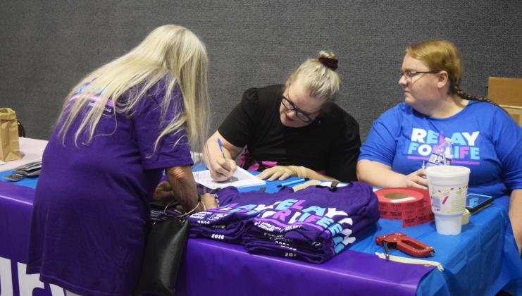 White County Relay for Life organizer Denise Miller, center, and her daughter-in-law Cassi Miller, right, assist Brenda Jolly, left, at the registration table. DENISE ETHERIDGE/WCN
