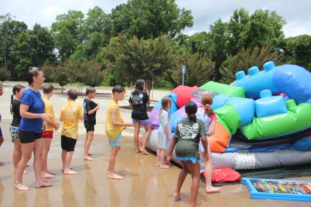 WCJLEA cadets and volunteers wait in line to race on an inflatable at the first session of WCJLEA held last week.