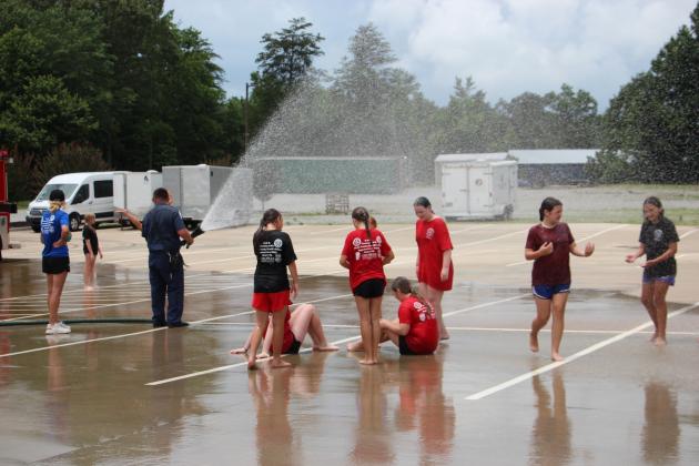 White County Junior Law Enforcement Academy cadets cool down with help from the White County Fire Department.