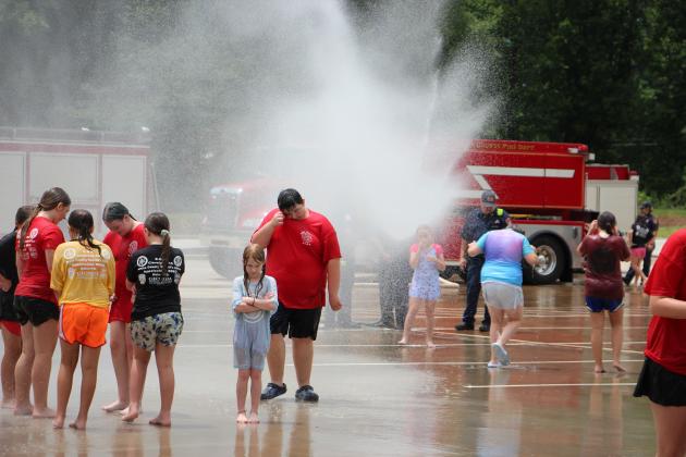 Cadets and volunteers take turns being sprayed by a fire department hose during the White County Junior Law Enforcement Academy. The annual summer program gives rising fourth-, fifth- and sixth-grade students hands-on experience with local public safety agencies.