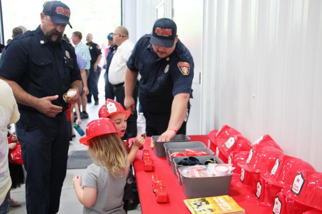 White County firefighters hand out goodies to children during the grand opening celebration for White County Fire Station 9 on June 11. CARLY HENDERSON/WCN