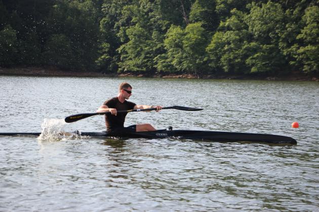 Walker Peck, 23, Masters coach at Lanier Canoe &amp; Kayak Club, paddles in the water during a training session. CARLY HENDERSON/WCN