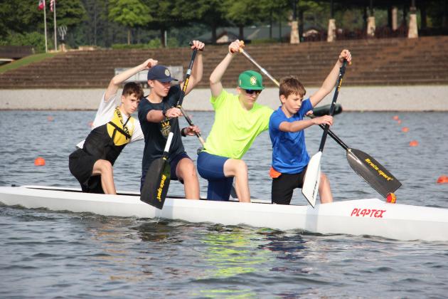From left, Maxim Horunovych, Kellen Sosebee, Vadim Kanyuka and Nazariy Semshchyn paddle in a C-4 high-kneel canoe during training at Lanier Canoe &amp; Kayak Club. CARLY HENDERSON/WCN