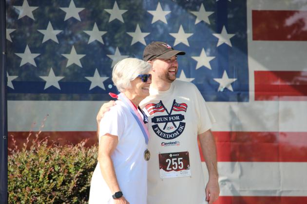 Councilmember Nan Bowen stands with Mayor Josh Turner after placing first in her age division in the 5K.