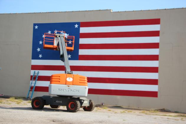 A flag mural is painted on a downtown Cleveland building ahead of Independence Day.