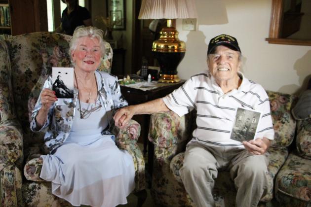 Monique Souris and Andy Negra smile as they hold photographs of their younger selves during a visit last week at Negra’s home, where they met more than 80 years after the liberation of Lorient, France.