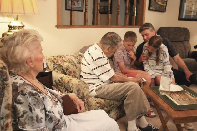 Monique Souris watches as Andy Negra speaks with her son, Francis, and her great-grandchildren during a visit last week at Negra’s home.