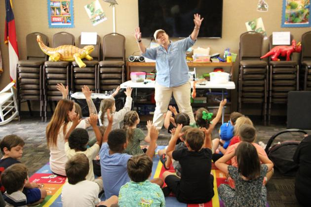 Kathy Church of Smithgall Woods State Park talks with children about spiders, snakes and insects during the Cleveland Library’s “Creepy Crawlies” program on June 24. Church shared facts about the critters and answered questions from attendees. PHOTOS BY CARLY HENDERSON/WCN
