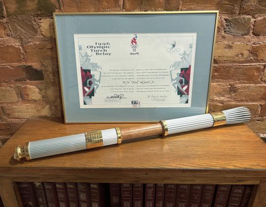 Atop an oak bookcase in my office sits the Olympic torch that I carried in 1996. An added memory was that our son Eric trotted along beside me. DINK NESMITH/CNI