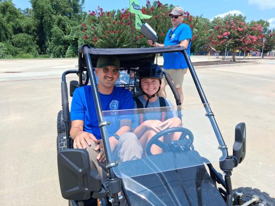 Sterling Hughes and Officer Pete Dorsey are ready to ride as they prepare to take on the cone obstacle course at this week’s Junior Law Enforcement Academy.
