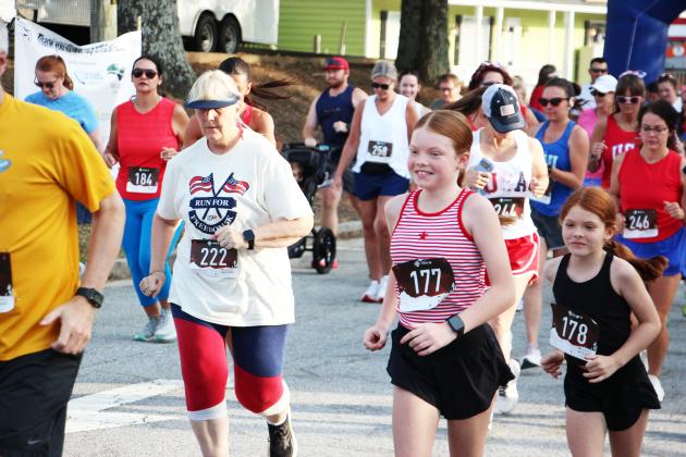 Kayleigh Dale, 10, and Jaycie Dale, 8, run alongside their fellow racers during the Run for Freedom 5K on July 4. The Dales came in first- and second-place in their age group. See more race photos in our Sports section.