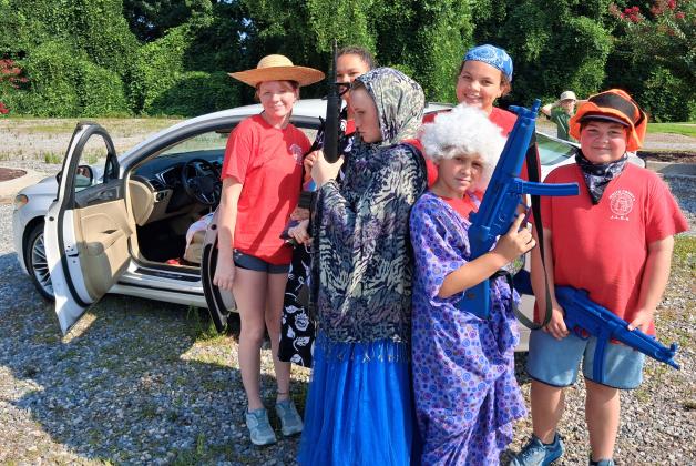 Former JLEA graduates were happy to play their part in helping new attendees learn the basics of law enforcement. These White County middle school students played a group of gun-wielding gang members at the traffic stop station of the academy. From left are Kaylee Loggins, Mary Brenton, Ezabella Loggins, Aaliyah Lemons, Christian Wood and Cole Peck.