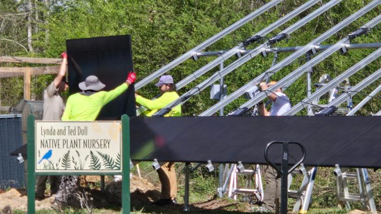 Workers install solar panels as part of the Sautee Nacoochee Center’s new solar energy system. The project includes 40 ground-mounted panels and 30 roof-mounted panels, which are expected to provide long-term energy savings for the center. SUBMITTED PHOTO