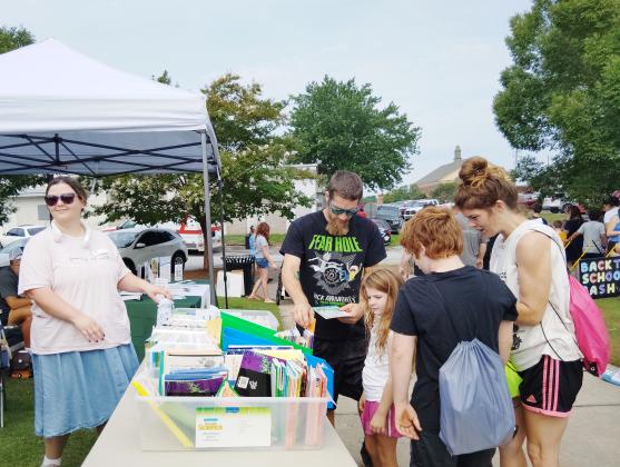 Jordan Stewart with White County Family Connection gives out story books to children during the event.