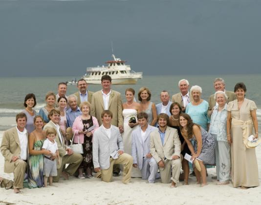 When the Cumberland Princess—loaded with the wedding party—pulled out of the port in St. Marys, the skies were picture-perfect blue on Aug. 11, 2007. But as Alan and Heather exchanged vows on the beach, Mother Nature unleashed a torrent of wind and rain. Nineteen years later, the couple smiles and looks back on surviving the unexpected storm as a testament to their enduring love for each other. (Photo by Gary Gruby)