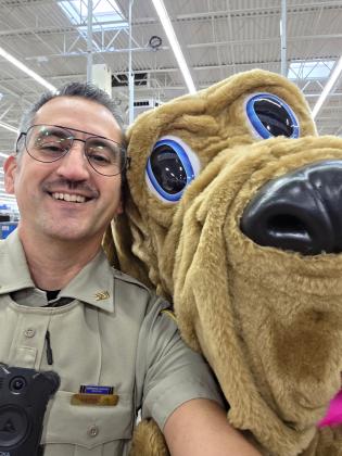 White County Sheriff's Office Deputy Pete Dorsey poses with Champ, the mascot of the Georgia Sheriffs' Association's C.H.A.M.P.S. (Choosing Healthy Activities and Methods Promoting Safety) program.