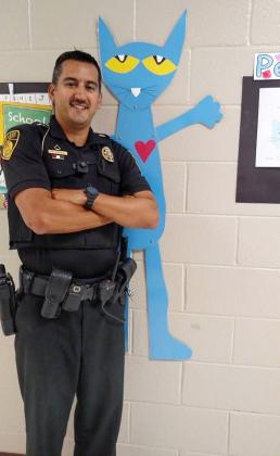 Deputy Pete Dorsey poses with Pete the Cat at Jack P. Nix Elementary School. Students often call Dorsey "Pete the Cat," a nickname inspired by both the popular children's book character and his first name.