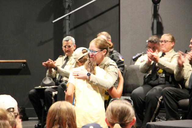 Deputy Hannah Hammack with the White County Sheriff’s Office gives a cadet a hug after presenting her with an award at WCJLEA Week 2 graduation.