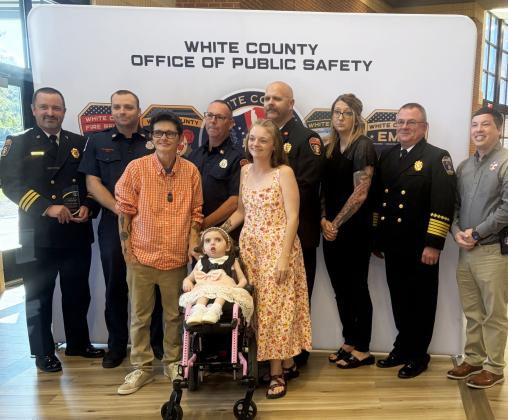 Pictured with Aurelia Day are her grandmothers, Amanda Hansen, left, and Kayla Hansen, right, along with public safety personnel back from left, Josh Taylor, Trace Swoszowski, Terry Stewart, Jody Holland, Jessica Wood, Don Strength and Jonathan Jones with GEMA. SUBMITTED PHOTOS