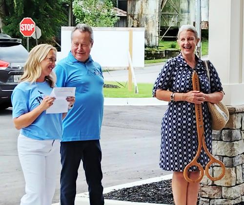 Soaring Therapy &amp; Learning Center co-owners Julie Barrett, left, and Steve Dalin, center, thank staff, patients' families and supporters prior to a ribbon cutting ceremony as White County Chamber of Commerce President Beth Truelove, right, looks on.