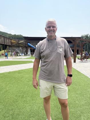 Camp Director Jon Estes stands in front of the new playground built for the elementary school-age camp at Woodlands. ERBELE/WCN