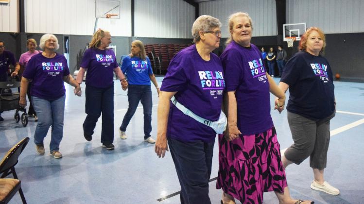 Denise Miller, front row center, walks the survivor’s lap with fellow cancer survivors at last year’s Relay for Life. FILE PHOTO