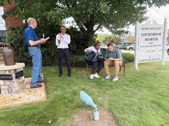 Foundational Literacy co-founder John Aiken, left, speaks with WSB TV reporter Berndt Peterson, while videographer Deja Pino, seated, left, records Joe Edlhuber on the grounds of the White County Historic Museum Aug. 26. LINDA ERBELE/WCN