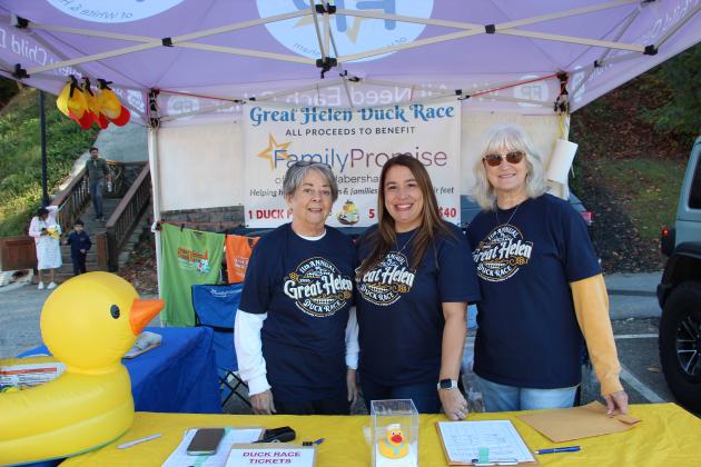 From left, Kathy Johnson, Martie Brooks and Cheryl Page encourage Oktoberfest attendees to participate in the Great Helen Duck Race. MAE SULLENS/WCN