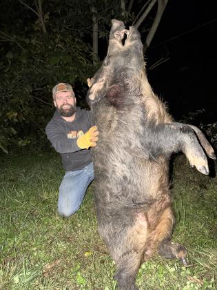 Jordan Dawson with the hog killed on Oct. 11. SUBMITTED PHOTO