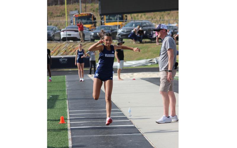 Kady McCullough won the girl's triple jump during the open day of events at the region meet. MARK TURNER/WCN