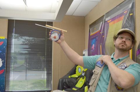 Scott Cantrell explained how UFO reports can be classified under a variety of categories by MUFON. He is shown with a tool used to gauge the angle of an object spotted, in relation to the horizon. (Photo/Stephanie Hill)