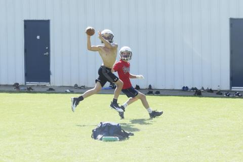 Cam Wilson, left, jumps in front of receiver Trevor Butler to pick off a pass during a one-on-one drill Tuesday morning at the White County Middle School stadium. (Photo/Mark Turner)