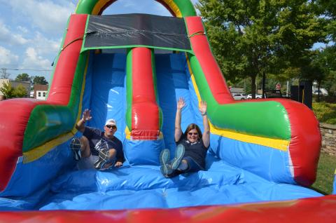 It was a battle of the superintendents as Dr. Laurie Burkett and Scott Justus raced each other down the bouncy slide at the block party held by the White County School System on Sunday, Sept. 15. More photos from the event are in this week's White County News. (Photo/Stephanie Hill)