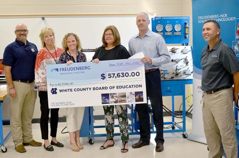 Shown from left are WCHS industrial mechanics teacher Tim Mayo, Assistant Principal Angie Helton, Principal Mary Anne Collier, White County Schools Superintendent Dr. Laurie Burkett, Gary VanWambeke (Freudenberg NOK vice president for Global Lead Center Transmission and Driveline Seals) and Wyman Hare, Cleveland plant manager for Freudenberg NOK. (Photo/Wayne Hardy)