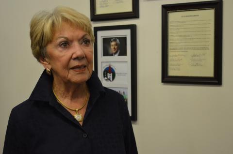 Linda Fowler stands in front the installation of Bob Fowler on the Hall of Fame, which includes a picture of Bob Fowler. (Photo/Stephanie Hill)
