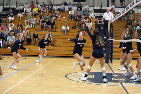 Kyleigh Johnson, right, sets up Hope Thomas for a kill during thea win over West Hall. (Photo/Staci Sulhoff)
