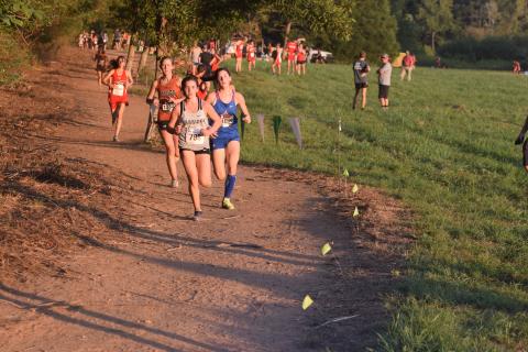 Sydnee Nix leads a pack of runners through the first mile of the varisty girls' race at the North Hall Invitational. (Photo/Mark Turner)