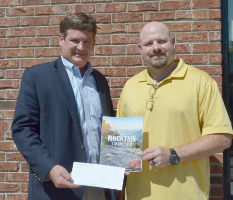 Community Newspapers Inc. Regional Publisher Alan NeSmith (left) presents Joe Gralton of Cleveland with the $100 prize for winning the cover photo contest for fall 2019 edition of The Mountain Traveler. (Photo/Stephanie Hill)