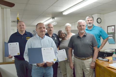 The Cleveland City Council recognized police officer Raymond Rutledge and firefighters Martin Godfrey and Lt. Mark Gunter at their meeting on Monday, Oct. 14. Pictured, front from left, are Rutledge and council member Bradley Greene; back from left, Godfrey, Gunter, council members Annie Sutton, Nan Bowen and Kevin Stanley. (Photo/Stephanie Hill)