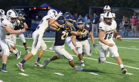 WCHS running back Riley Stancil uses a block from Reece Dockery to turn the corner during the 7-AAAA matchup  against Marist last Friday in Atlanta. (Photo/Mark Turner)