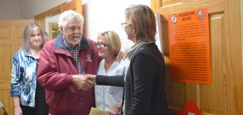 Fred Garmon and Cinnamon Spurlock shake hands after Helen election results are announced. Former city commissioner Dona K. Burke is shown in the middle. (Photo/Stephanie Hill)