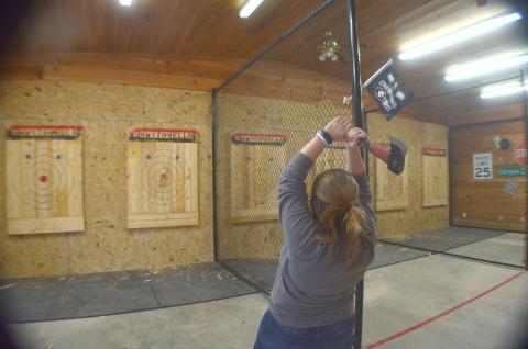 Jana Vaughan takes aim during a round of axe throwing at Highway to Hell’n near Cleveland. (Photo/Wayne Hardy)