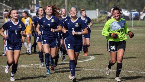 Madison Wright, Lauren Bergevine, and Tori Wilson take the field before the start of the NAIA national tournament game last week in West Palm Beach. (Photo/TMU Athletics)