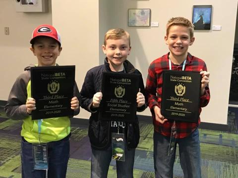 Mossy Creek students Hunter Moyers, Brody Kelley and Zachary Godfrey all proudly hold up their awards from the state competition last week in Savannah. (Submitted photos)