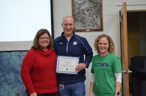 Superintendent Dr. Laurie Burkett, left, and WCHS principal Mary Anne Collier, right, present a certificate to Craig Turner. (Photo/Stephanie Hill)